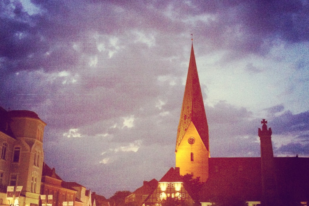 The market square at night, featuring the church clock tower.